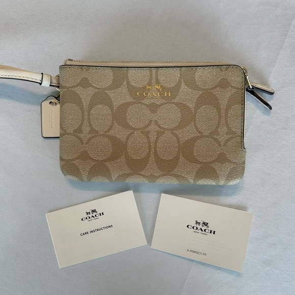 Coach Handbags - Coach Signature Double Zipper Wristlet in Tan and White with gold trim.